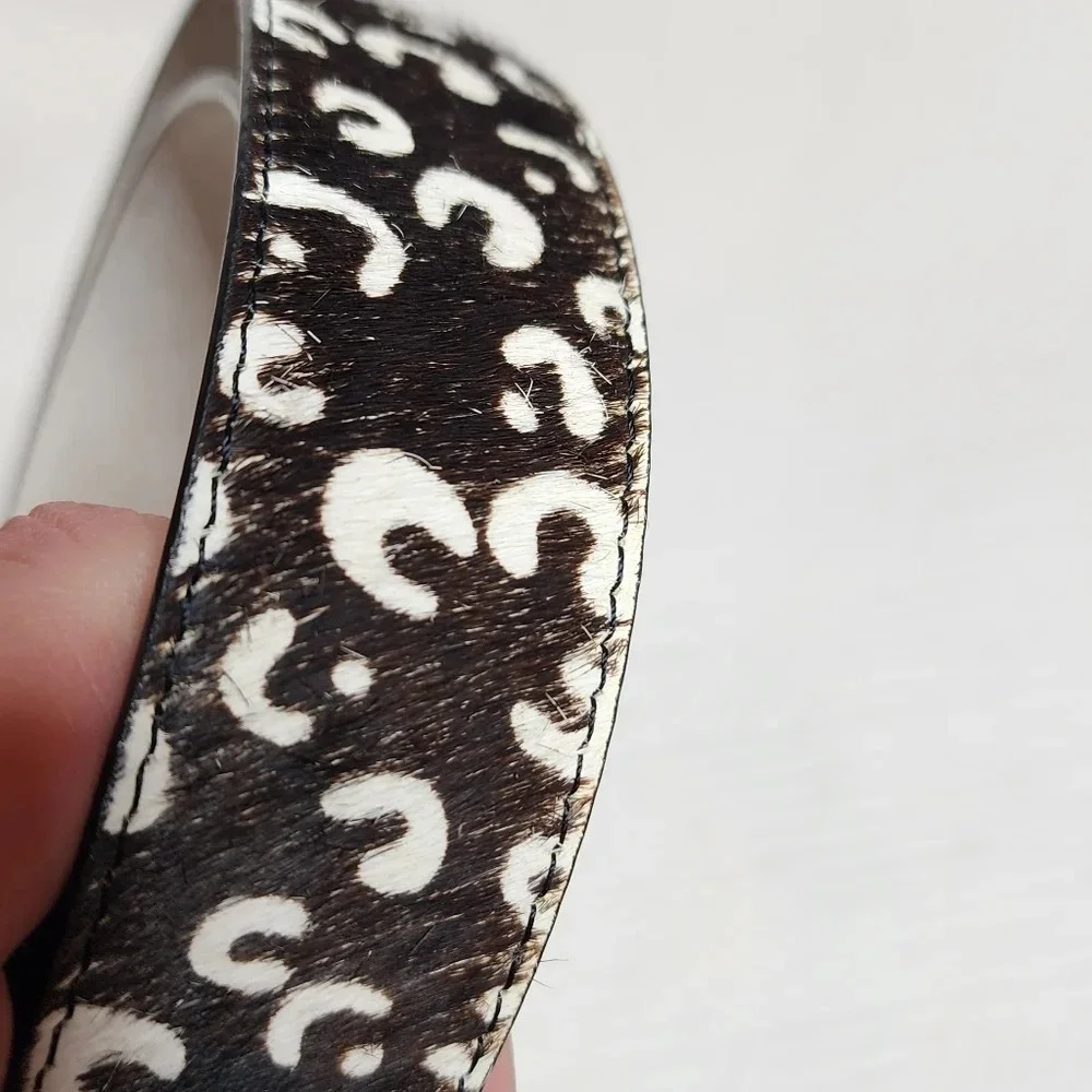 100% calf hair leather‎ dark brown, white spotted belt.